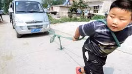 Bé 7 tuổi cõng 90 kg và kéo ô tô gần 2 tấn