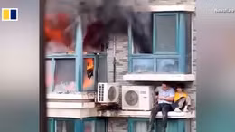 Người đàn ông Trung Quốc tay không leo lên toà nhà đang bốc cháy cứu người